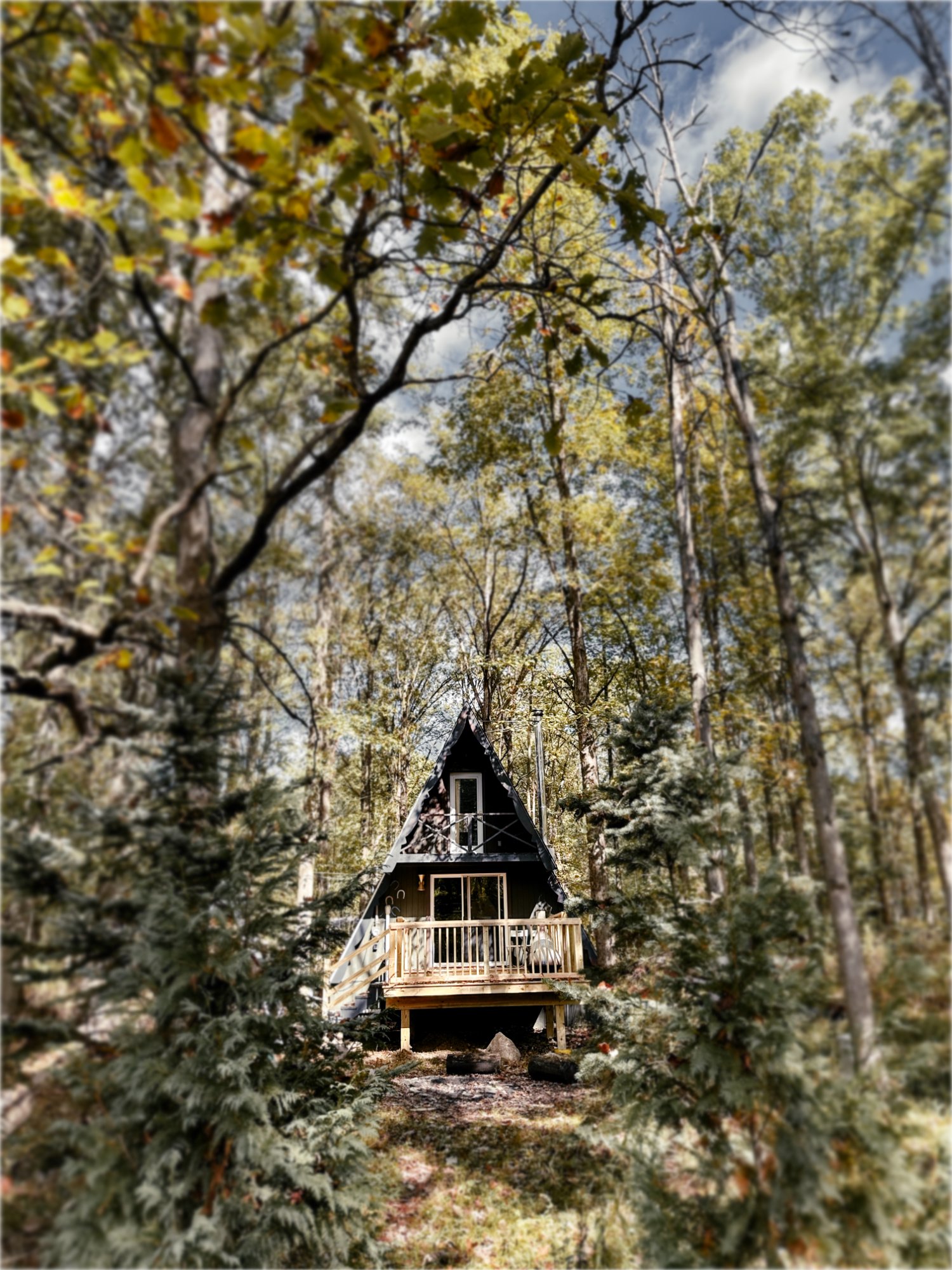 The Triangle A-frame cabin nestled among the trees in West Farmington, Ohio